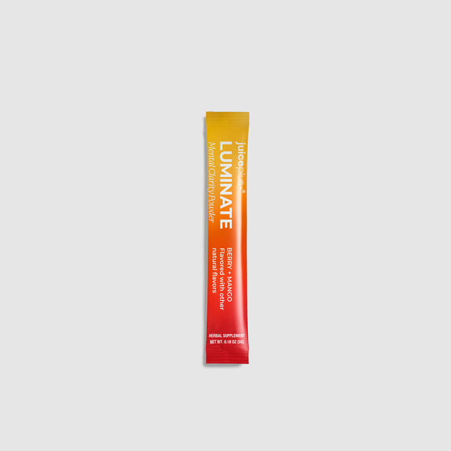 A single-serve stick pack of Luminate Facial Toner in Berry + Mango flavor, featuring a vibrant orange-to-red gradient design with white text, centered on a light gray background.